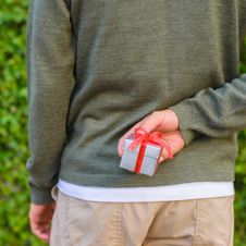 Man Hide Gift Box Behind His Back Royalty Free Stock Photos Man Hide Gift Box Behind His Back Royalty Free Stock Photos
