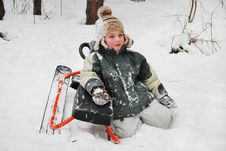 Boy Sitting In The Snow With Sledges. Royalty Free Stock Image