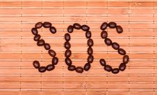 SOS From Coffee Beans On A Decorative Straw Royalty Free Stock Image SOS From Coffee Beans On A Decorative Straw Royalty Free Stock Image