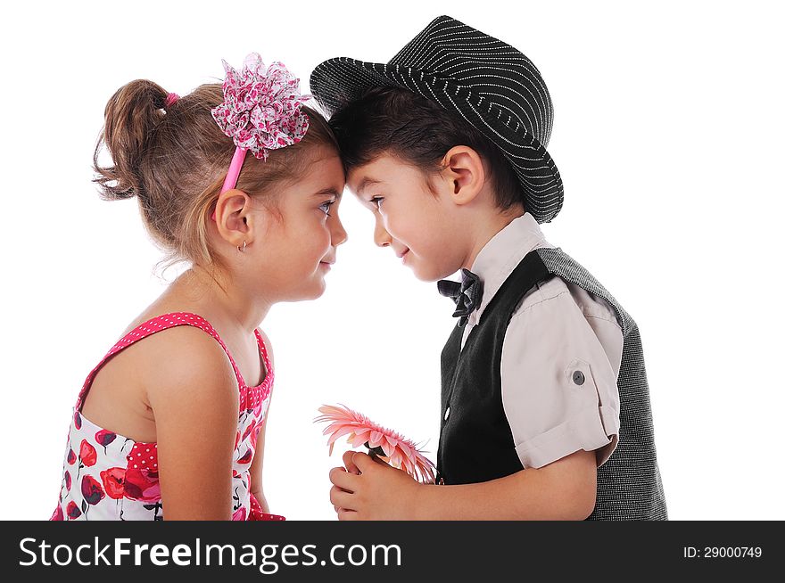 3-4 years Boy and girl looking at each other. The boy is holding a flower. Studio shot, white backgroud. 3-4 years Boy and girl looking at each other. The boy is holding a flower. Studio shot, white backgroud