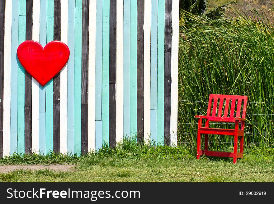 Red Heart symbol and red lonely chair. Red Heart symbol and red lonely chair