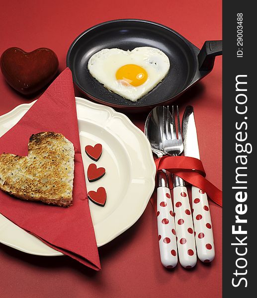 Love theme Valentine breakfast with heart shape egg and toast, vertical.