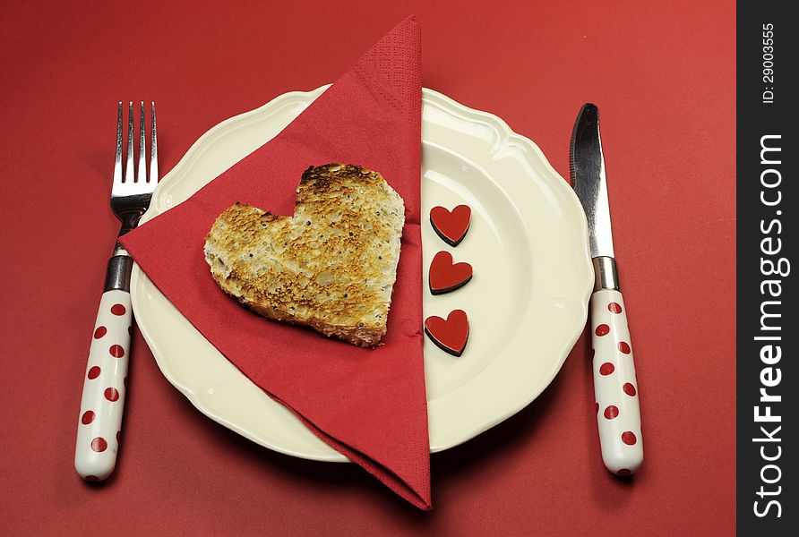 Red theme Valentine breakfast with heart shape toast with love hearts on red background. Red theme Valentine breakfast with heart shape toast with love hearts on red background.