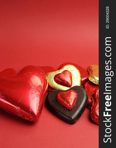 Red And Gold Wrapped Chocolates, Vertical With Copy Space.