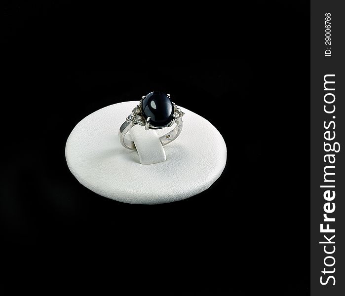 Ring with onyx stone backing with black background