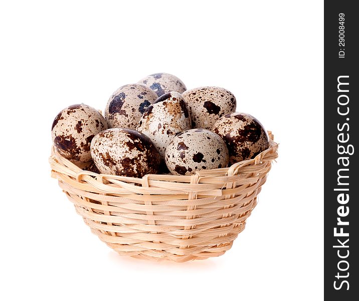 Quail eggs in a basket on a white background. Quail eggs in a basket on a white background