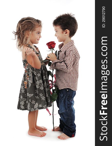 Smiley and cute children are holding a red rose. Smiley and cute children are holding a red rose