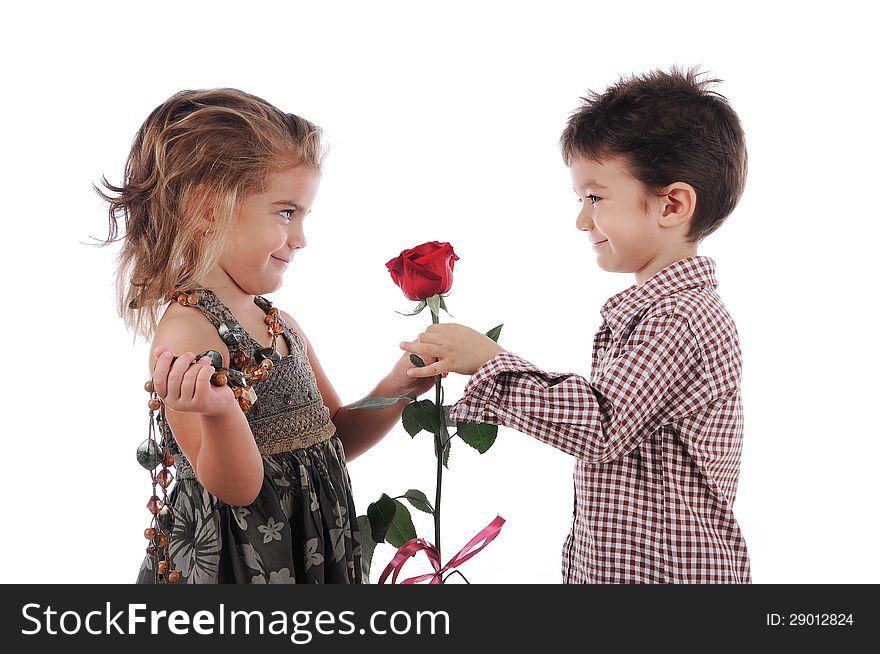 Smiley and cute children are holding a red rose and they are looking at each other. Smiley and cute children are holding a red rose and they are looking at each other