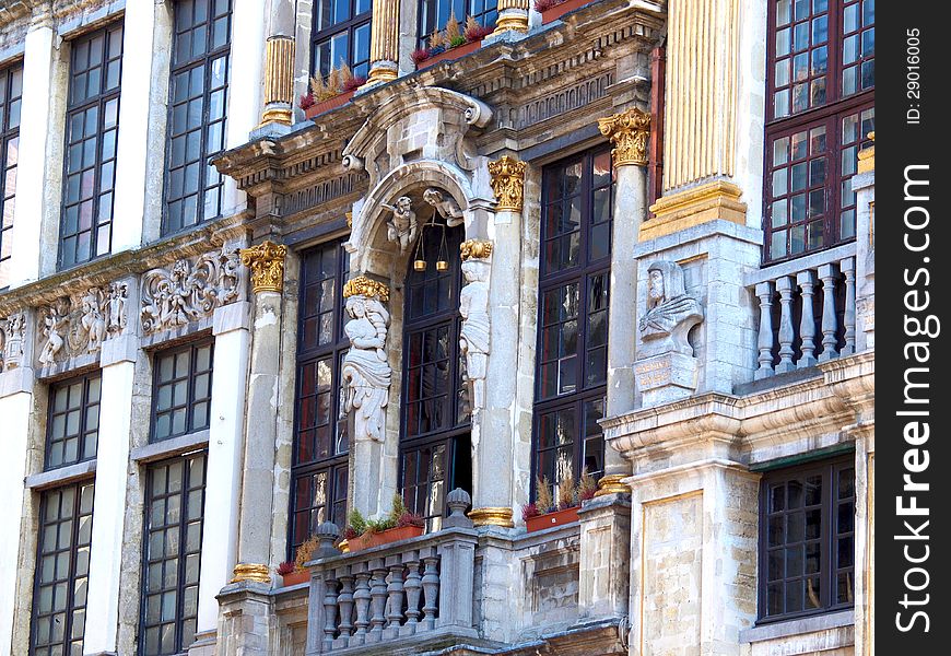 Grand Place In Brussels. Architectural detail at the Grand place statue on the balcony Belgium.