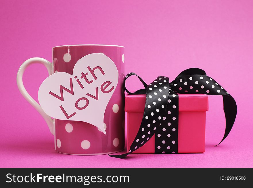 Cute and sassy pink mug and gift with polka dot ribbon and 'with love' message on heart shape gift tag. Cute and sassy pink mug and gift with polka dot ribbon and 'with love' message on heart shape gift tag.