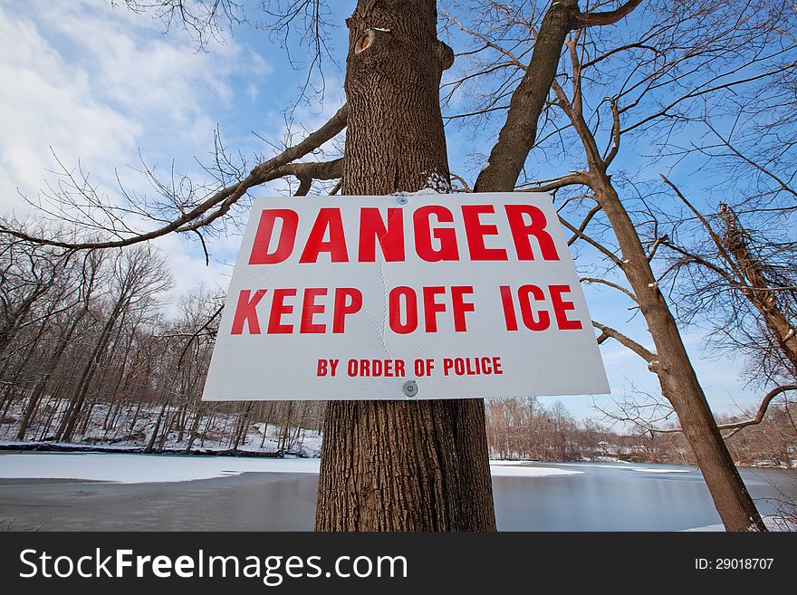 Warning sign to keep off the ice on the lake. Warning sign to keep off the ice on the lake