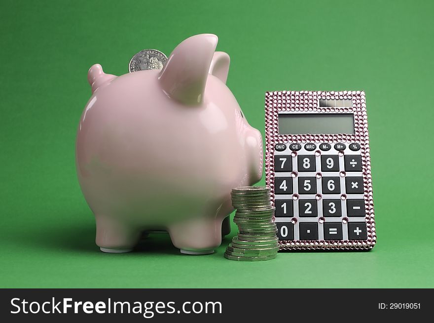 Savings and Shopping Sale concept with piggy bank, stack of coins and calculator against a green background.