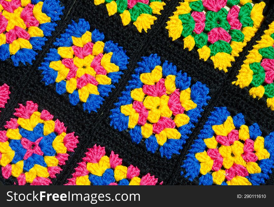 Colorful cotton granny square. Crochet texture close up photo. Knitted zigzag handmade jewelry