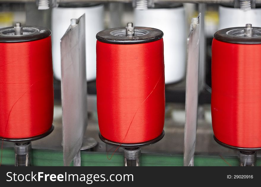 Colorful spools of thread in a textile factory