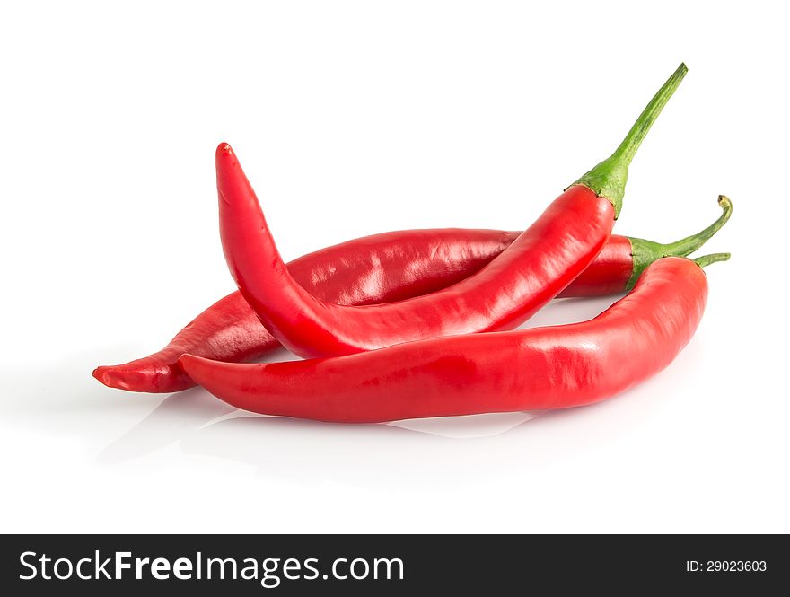 Three red hot peppers isolated on white