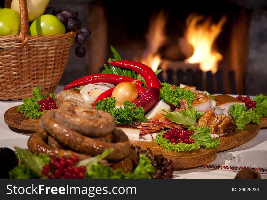 Traditional Ukrainian food on the table by the fireplace. Traditional Ukrainian food on the table by the fireplace