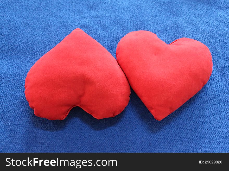 Red heart-shaped pillows - symbol of Valentines day.