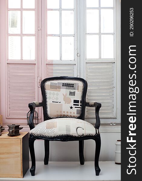 refurbished antique chair over antique white and pink window