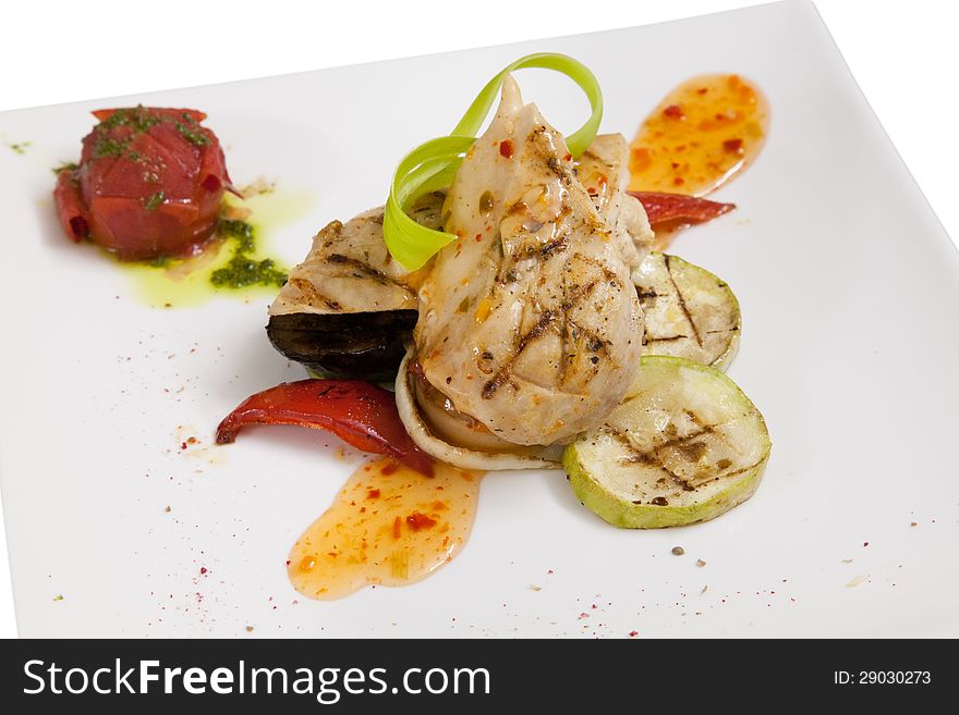 Grilled chicken breast with vegetables on white plate