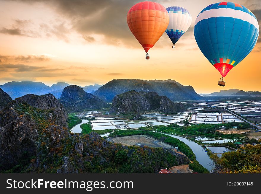 Hot air balloons floating up to the sky over mountain