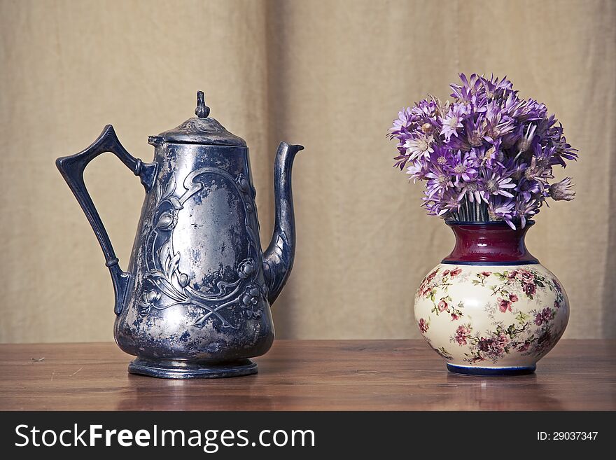 Sooty old teapot on old table in open old kitchen. Sooty old teapot on old table in open old kitchen