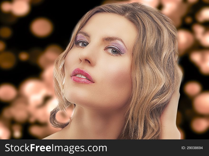 Fashion portrait of young blond woman standing against artistic background.high-end retouching