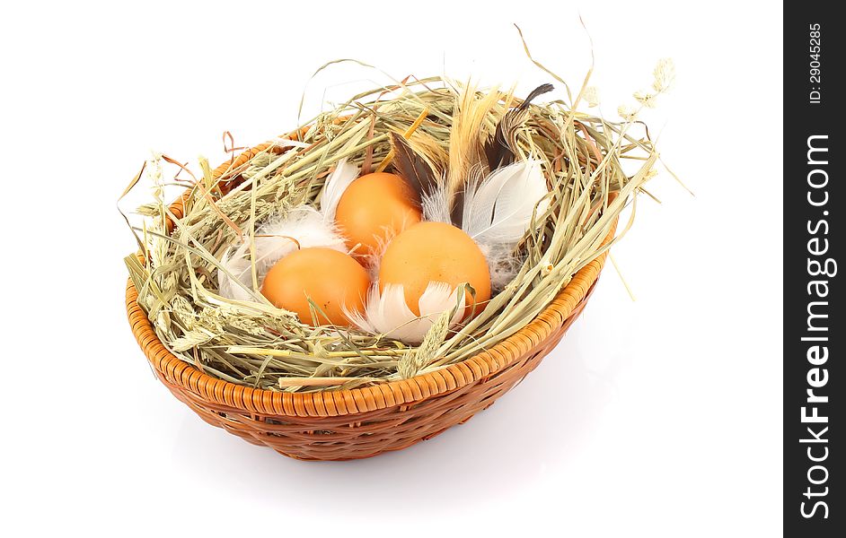 Brown eggs in wooden basket with hay and feather, food ingredient photo. Brown eggs in wooden basket with hay and feather, food ingredient photo