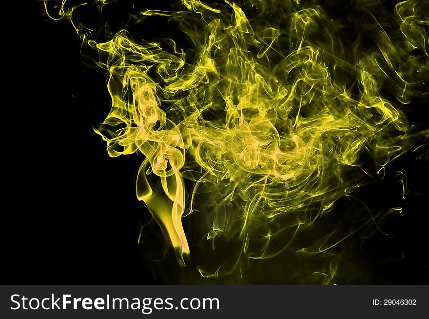 Abstract yellow smoke on black background. Good for your design