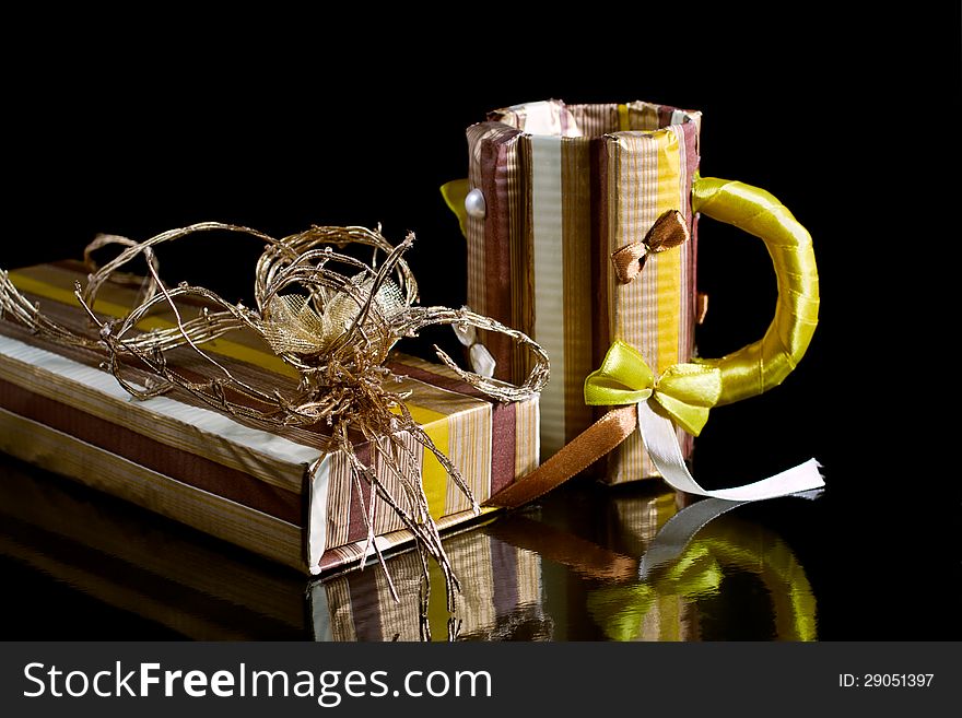 Paper gift box and paper mug on a black background