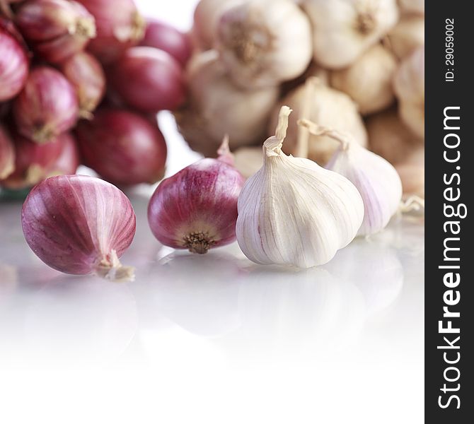 Onions and garlic on white background