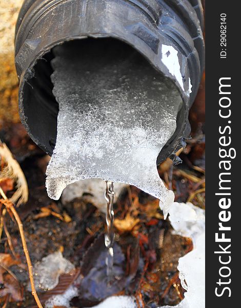 Melting snow and ice clogged in plastic drainage pipe. Melting snow and ice clogged in plastic drainage pipe.