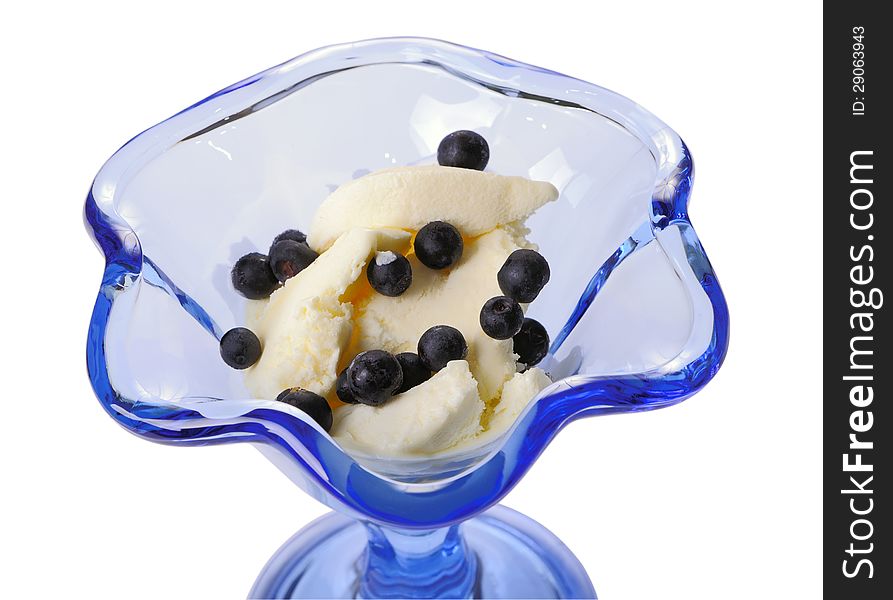 Ice cream with bilberry in a blue glass ice-cream bowl isolated on white