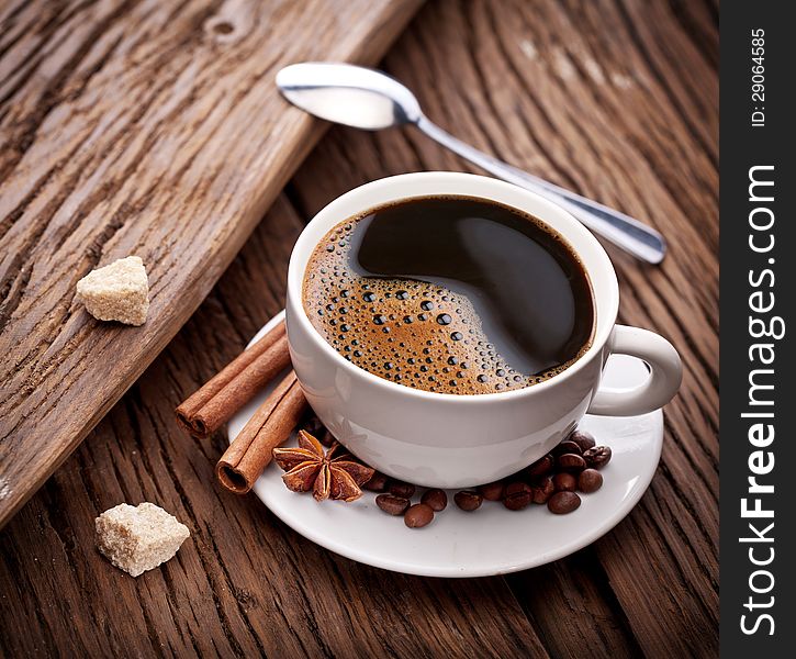Cup of coffee with brown sugar on a wooden table. Cup of coffee with brown sugar on a wooden table.