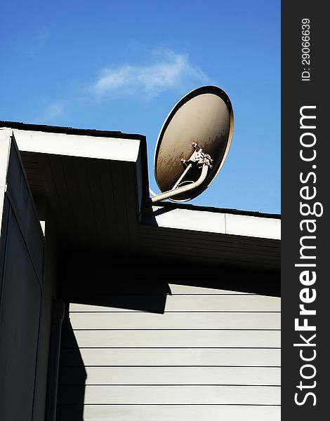 Satellite dish Antenna mounted on the roof with blue sky in the morning time