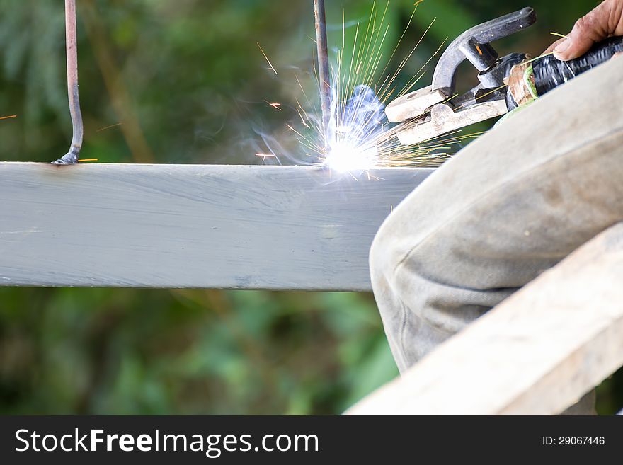 Welder welding elements at the construction site