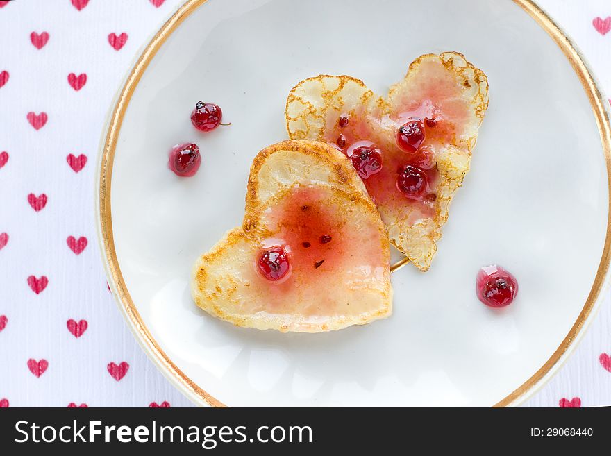Heart-shaped pancakes with jam.