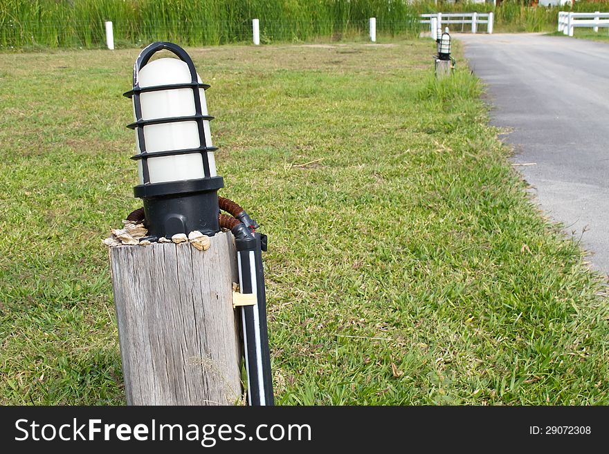 Street lamp pole on green grass