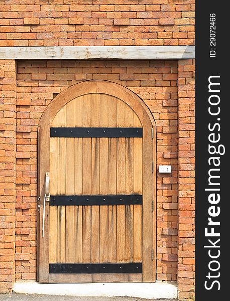 Wooden door with brick wall