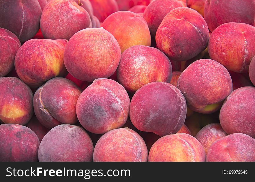 Fresh ripe peaches in the box ready for sale on marketplace