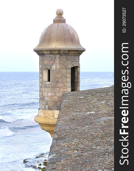 Turret at the corner of the thick wall of the fortress of San Juan overlooking the Atlantic Ocean. Turret at the corner of the thick wall of the fortress of San Juan overlooking the Atlantic Ocean