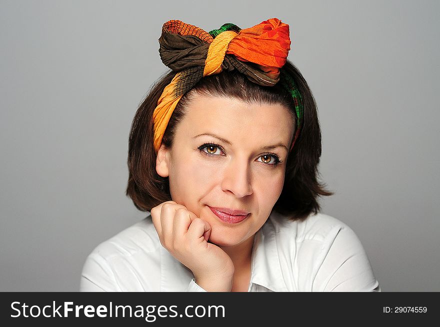 Girl with a colorful scarf in a studio