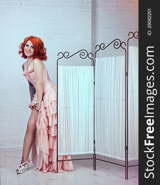 Sensual young woman with red hairs posing in studio. Sensual young woman with red hairs posing in studio