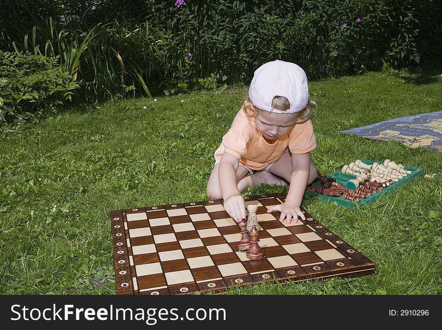 Girl playing chess, herb, flowers