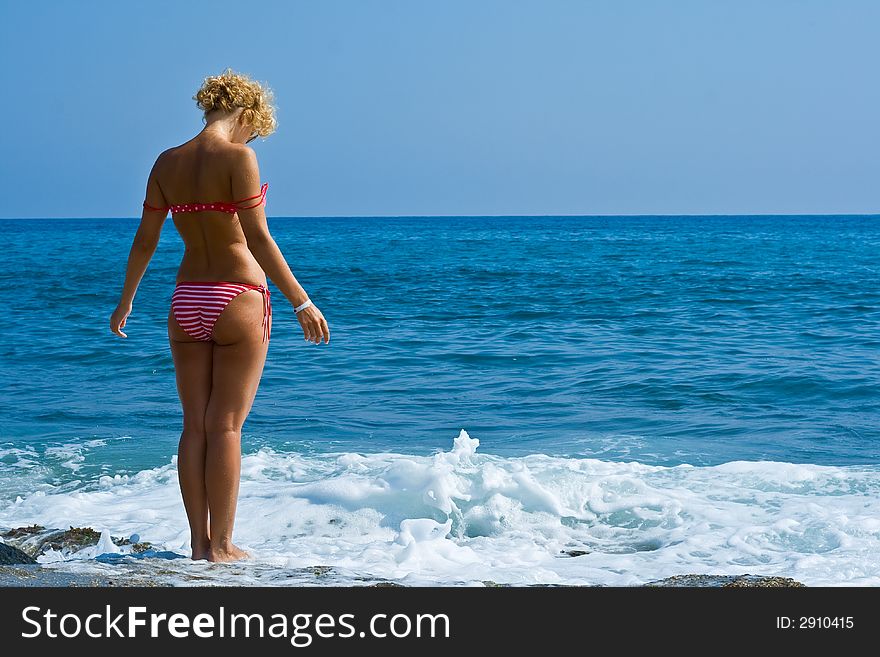 The girl looks at the sea, having placed hands in the parties. The girl looks at the sea, having placed hands in the parties