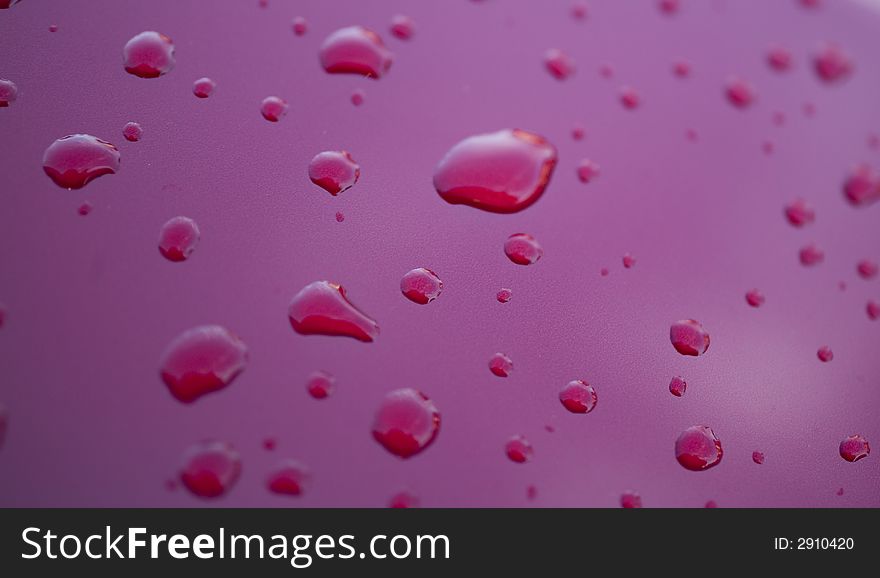 Water rain droplets on red glass background drop. Water rain droplets on red glass background drop