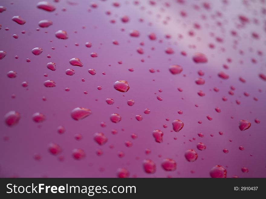 Water rain droplets on red glass background drop. Water rain droplets on red glass background drop