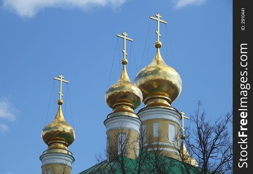 Domes of a orthodox temple on the background of a blue sky. Domes of a orthodox temple on the background of a blue sky