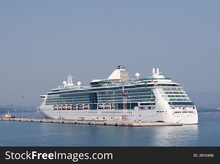 Big white luxury cruise ship in Corfu town port. Big white luxury cruise ship in Corfu town port
