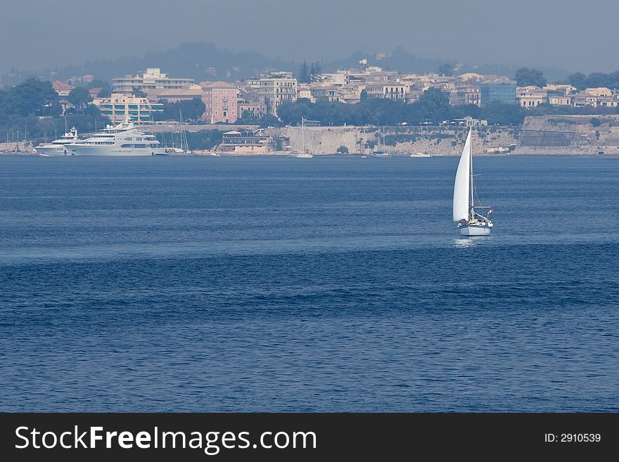 Small white yacht sailing near Corfu Island - Greece. Small white yacht sailing near Corfu Island - Greece