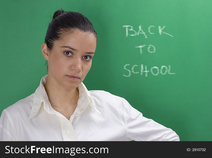Young beautiful teacher in white on green background. Young beautiful teacher in white on green background